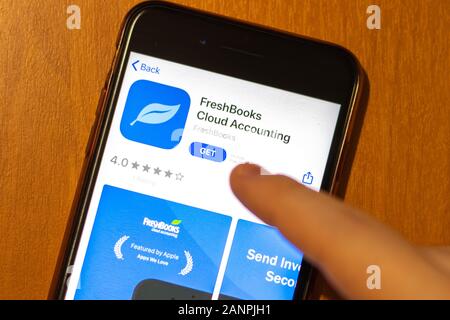 Los Angeles, California, USA - 17 January 2020: Mobile phone in hand with FreshBooks Cloud Accounting app logo on screen close-up, Illustrative Stock Photo