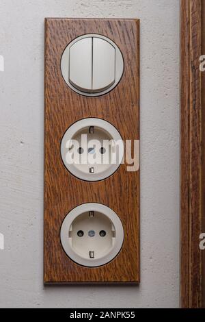 Electrical Socket And Switch In Retro Style On A Wooden Wall