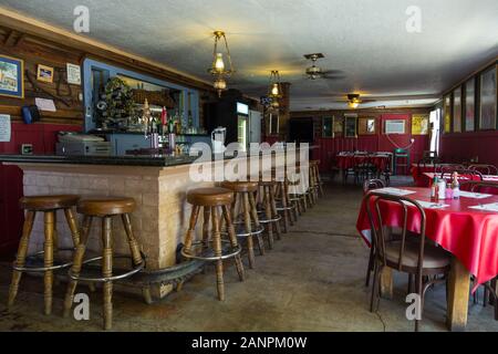 Shoshone, California, USA- 02 June 2015: Interior of Crowbar Cafe & Saloon. Old, traditional decor, classic bar and tables with red tablecloth. Stock Photo