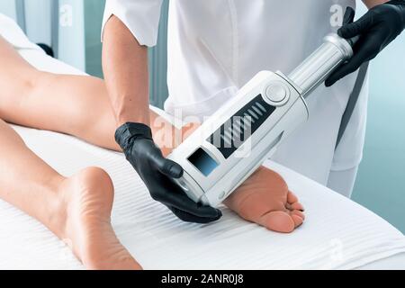 Partial view of cosmetologist in rubber gloves doing endospheres therapy Stock Photo
