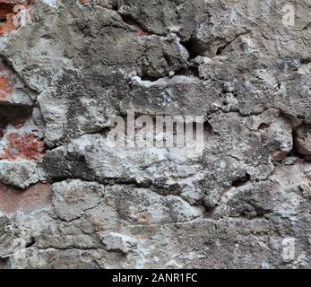 An old crumbling wall forms an irregular pattern that can be used for backgrounds. Stock Photo