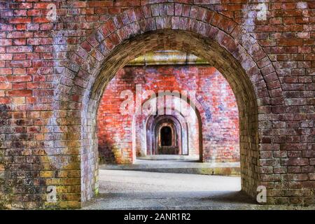 Throught the diminishing perspective of series of arches in old historic aqueduct made of red bricks in Japanese city Kyoto. Stock Photo