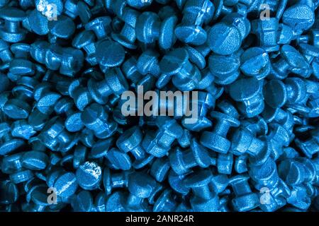 An abstract industrial full frame background of forged and sanded steel billets. Classic blue color toned backdrop.. Close-up with selective focus and Stock Photo