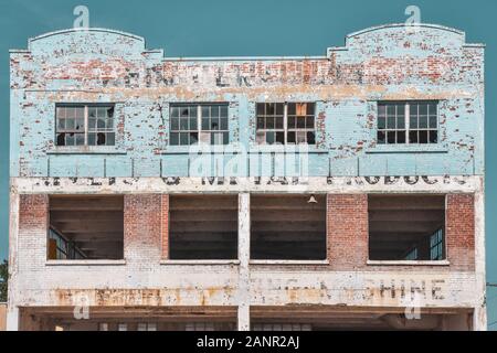 Decay concept. Building in ruins, with chipped paint, showing the good times of the past. Gananoque, Ontario, Canada. Stock Photo