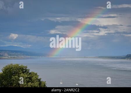 St. Lawrence River Landscape, Quebec Canada. On a cloudy day, with rainbows in the background. Concept of meteorology and nature. Stock Photo