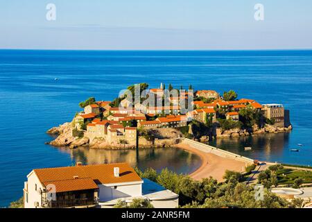 view of one of a beach of Budva town and the island of Sveti Stefan with famous hotel resort in Adriatic sea, Montenegro Stock Photo