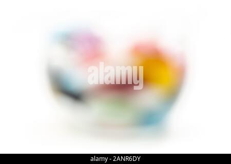 Blurred image of Glass full of flat polished stones Stock Photo