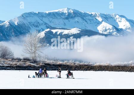 Ice fishing on Kinney Lake, below the Wallowa Mountains, Oregon. Stock Photo