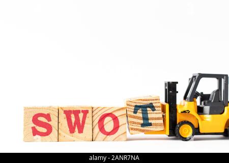 Toy forklift hold wood letter block t to complete word swot (abbreviation of strength, weakness, opportunities, threats) on white background Stock Photo