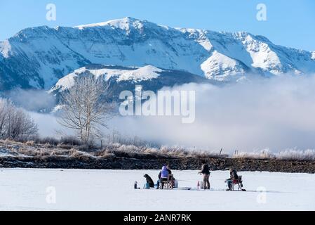 Ice fishing on Kinney Lake, below the Wallowa Mountains, Oregon. Stock Photo