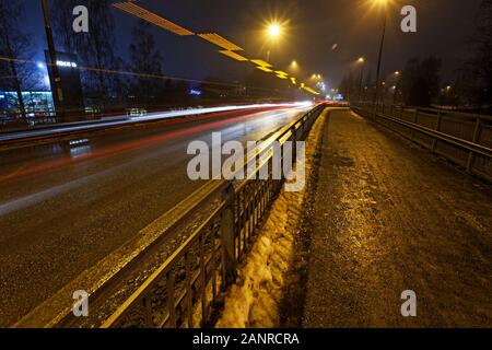 Umea, Norrland Sweden - November 26, 2019: bridge at night with snow and light trace from cars Stock Photo