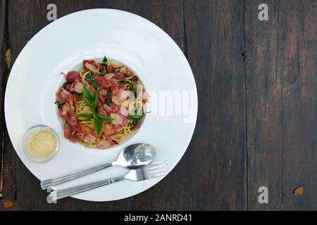 The spaghetti spicy bacon and ham with basil Stock Photo