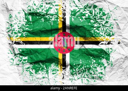 The national flag of the Dominica  is painted on crumpled paper. Flag printed on the sheet. Flag image for design on flyers, advertising. Stock Photo