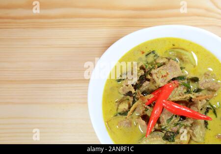 Top View of Thai Green Curry or Kaeng Keaw Wan with Beef Served on Wooden Table Stock Photo