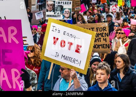 Jan 18, 2020 San Francisco / CA / USA - Participant to the Women's March event holds 'It's easy...VOTE...it matters!' sign while marching on Market st Stock Photo