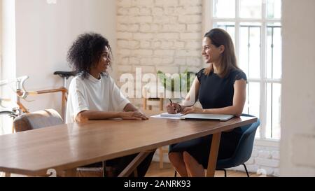 Happy businesswoman hr manager holding interview with job applicant Stock Photo