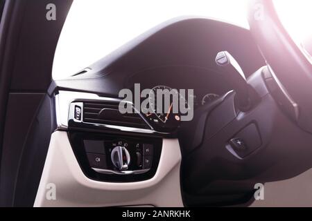 Car interior with light switch. The light knob in the car. Multifunction headlight console control switch. Turn on-off headlight switch in the car. Stock Photo