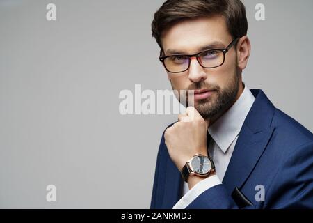 Studuo shot of thinking businessman wearing suit Stock Photo