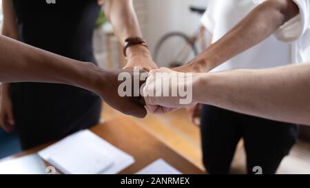 Motivated diverse business people fists bumping close up Stock Photo