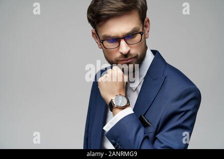 Studuo shot of thinking businessman wearing suit Stock Photo
