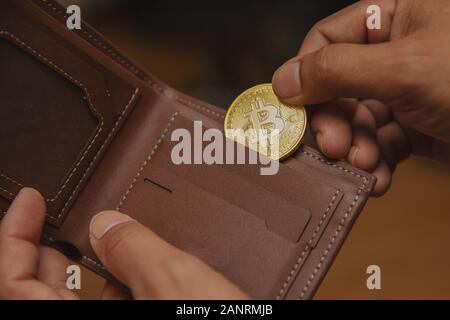 Bitcoin in the hands of business people are wearing a purse. Stock Photo