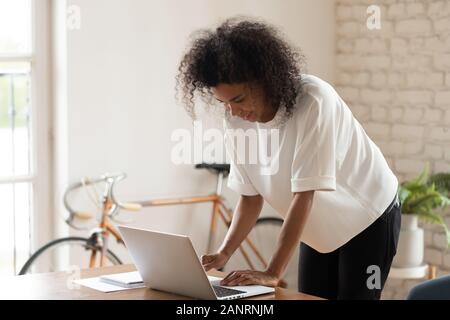 Confident African American businesswoman working on computer in modern office Stock Photo