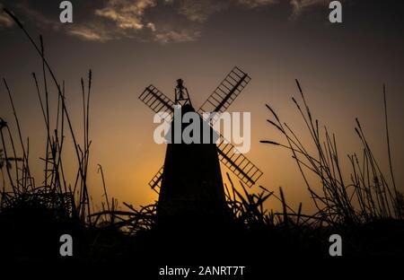 The sun rises behind the Allen Clarke Memorial Windmill in Blackpool, as the chilly weekend continued with the mercury dipping below zero and fog coating large parts of the country. Stock Photo