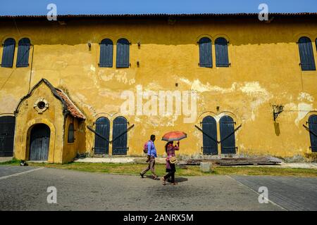 Galle, Sri Lanka - January 2020: Tourists walking in front of the Maritime Museum inside the Galle Fort on January 14, 2020 in Galle, Sri Lanka. Stock Photo