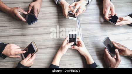 Group of friends using smartphone - People hands view having fun with mobile phones - Technology trends, and social networks app concept - Main focus Stock Photo