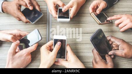 Group of friends having fun together with smartphones - Closeup of hands social networking with mobile cellphones - Wifi connected people creative off Stock Photo