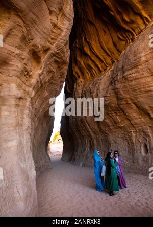 Tourists in al-Diwan in jebel Ithlib, Al Madinah Province, Alula, Saudi Arabia Stock Photo