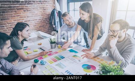 Business people meeting at office and use post notes to share idea. Brainstorming concept. Sticky note on glass wall. Stock Photo