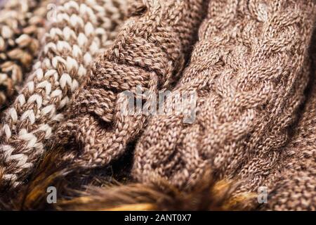 Woolly winter texture brown hats on the counter in the store. Close up. Stock Photo