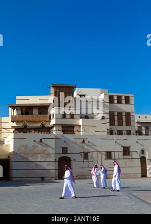 Saudi men in front of renovated historic house with wooden mashrabiyas, Al Madinah Province, Yanbu, Saudi Arabia Stock Photo