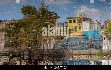 Inverted image. Reflection on the lake of colored houses that look like a watercolor painting. Stock Photo