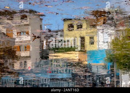Inverted image. Reflection on the lake of colored houses that look like a watercolor painting. Stock Photo
