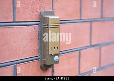 Intercom on a red brick wall close up Stock Photo