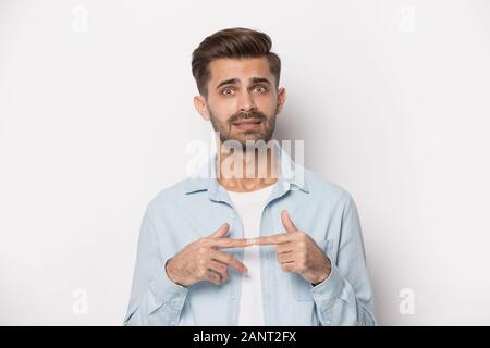 Stressed nervous young man feeling uncertain about complicated situation. Stock Photo