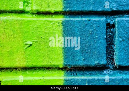 Close up The brick wall is painted in half green and turquoise in color. texture, background. Stock Photo