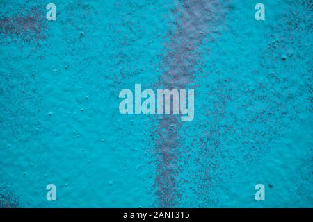 The plaster wall is painted with a Blue spray. Texture. Background Stock Photo