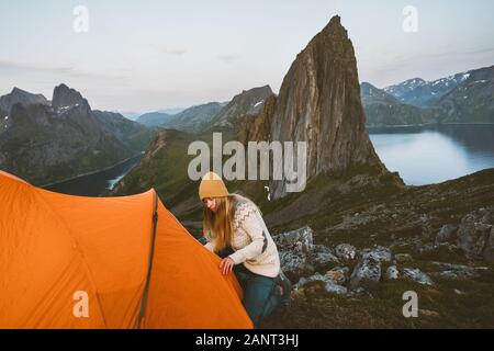 Camping in mountains woman with tent in Norway travel adventure healthy lifestyle active summer vacations Segla mountain view Stock Photo