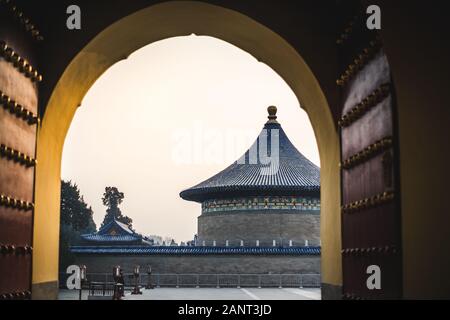 A view from a gate of a traditional chinese pagoda with blue roof at the Temple of Heaven, an imperial complex of religious buildings situated in the Stock Photo