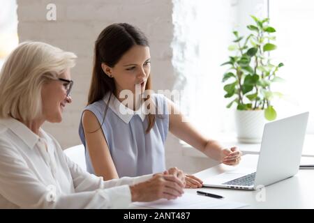 Middle-aged and young affiliates learning new corporate program Stock Photo