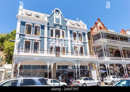 SIMONS TOWN, SOUTH AFRICA - DECEMBER 31 2010: Historic Victorian buildings in Simons Town with sidewalk coffee shops and cafes near Cape Town in the W Stock Photo
