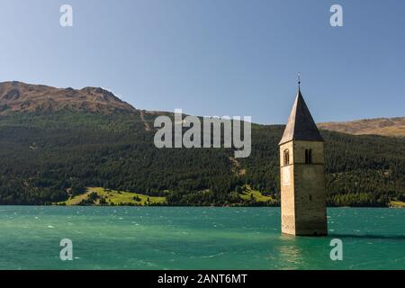Bell tower of a church sunken in Lake Reschen, Reschensee/Lago di Resia, South-Tirol, Italy Stock Photo