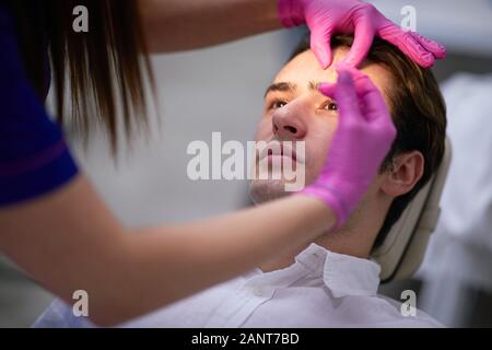 Random guy having wrinkle cosmetics, concept of men cosmetics Stock Photo