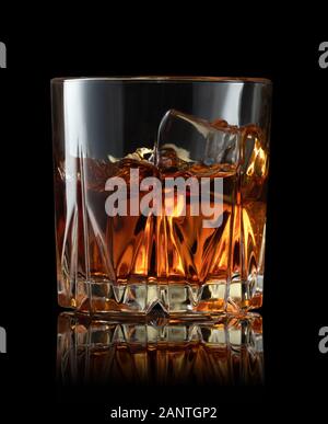 whiskey with ice cubes in glass on black background Stock Photo