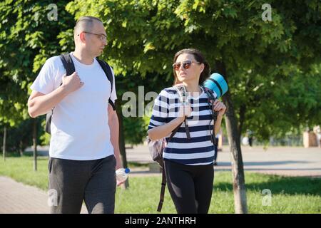 Outdoor walking man and woman, talking people middle-aged couple Stock Photo
