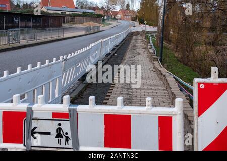 on one street the pavement is torn up and the ground dug up to lay a broadband cable Stock Photo