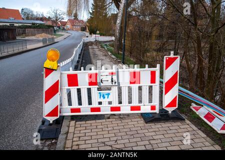 on one street the pavement is torn up and the ground dug up to lay a broadband cable Stock Photo